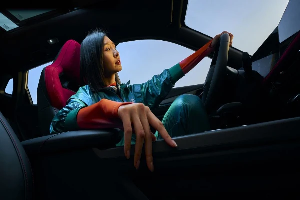 Changan X5 PLUS red-seat cabin with a driver in a staged manufacturer launch reference