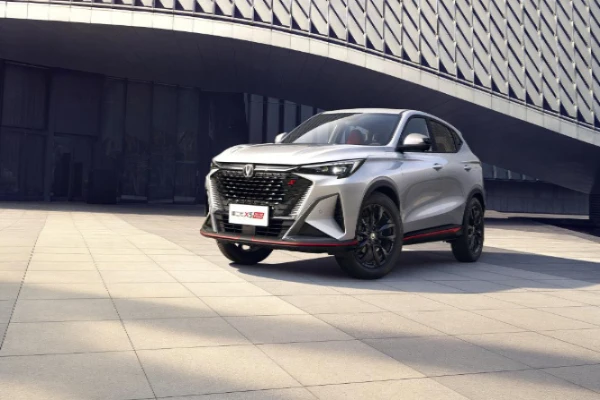 Silver Changan X5 PLUS outside a modern building in a 2024 launch reference